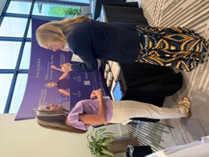 Dr. Flischel visiting a booth at the symposium